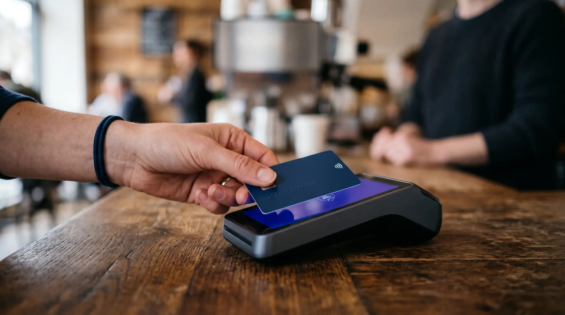 Customer tapping a card on a countertop terminal